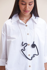 Intricate black and white Van Gogh-inspired necklace.